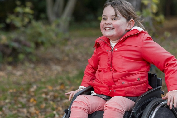 A young girl in a wheelchair enjoying the trails