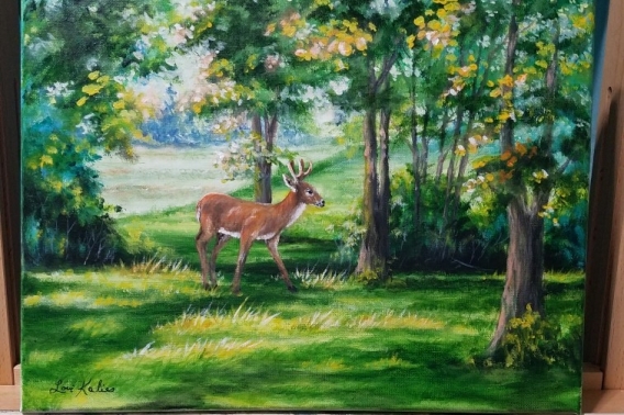A velvet painting of a buck in the forest. 