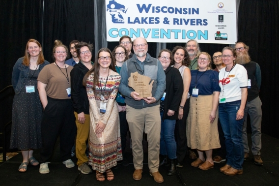 Tim Asplund accepting the Excellence in Professional Service Award with DNR team members.