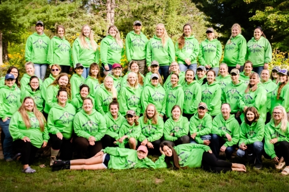 Women gathered for a group photo with matching green t-shirts