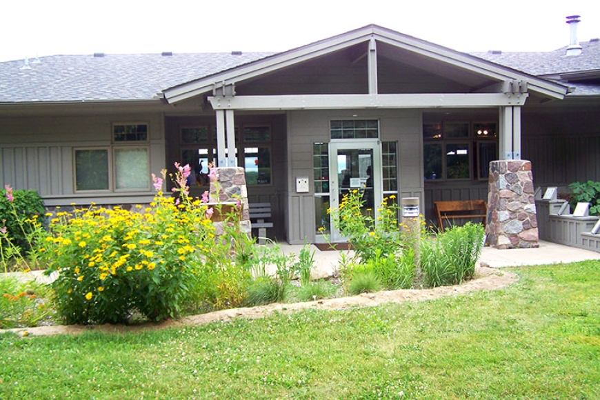 Outside the nature center looking at door, wildflower garden in bloom.