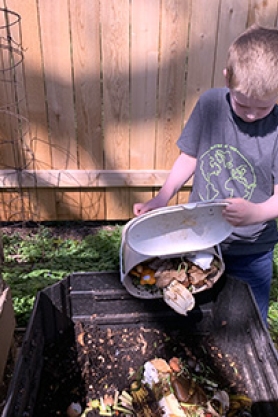 Dumping food scraps into home compost bin