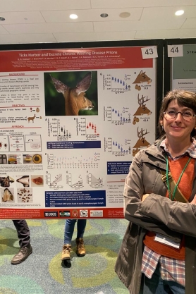 Heather Inzalaco stands by her poster depicting the results of her study on ticks.