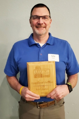 Larry Gates (City of Prairie du Chien, Village of Patch Grove, Village of Bloomington) holding his Operator of the Year award.