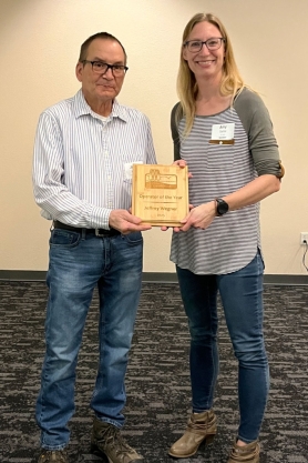 Jeff Wegner posing with Amy Garbe while holding award plaque for the 2025 Wastewater Awards.