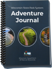 Blue book labeled Wisconsin State Park System Adventure Journal.