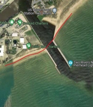 A map showing a example of man-made upland shorelines by Two Rivers Harbor within Manitowoc County using a red link to indicate the boundary.
