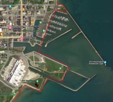 A map showing a example of man-made upland shorelines by Port Washington Harbor within Ozaukee County using a red link to indicate the boundary.