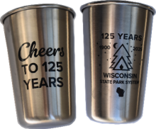 Unpainted steel cup with front labeled Cheers To 125 Years and back ouline of pine tree and tent labeled 125 Years 1900 2025 Wisconsin State Park System.