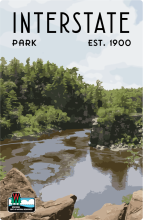 Rocky overlook of river and forest labeled Interstate Park Est. 1900.