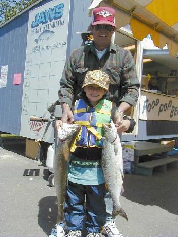 Man and girl with a Lake Trout and Chinook Salmon