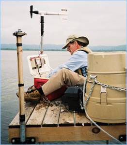Water quality specialist sampling from a platform