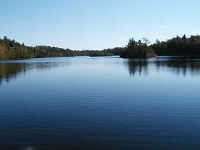 Wide shot of Bass Lake under clear blue skies.