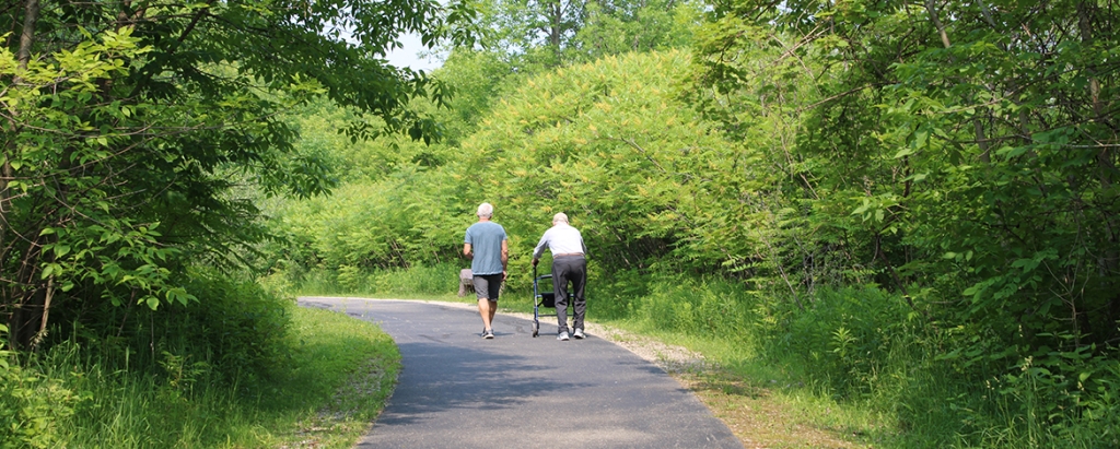 People taking a stroll along the Butterfly Pond Trail at High Cliff State Park.