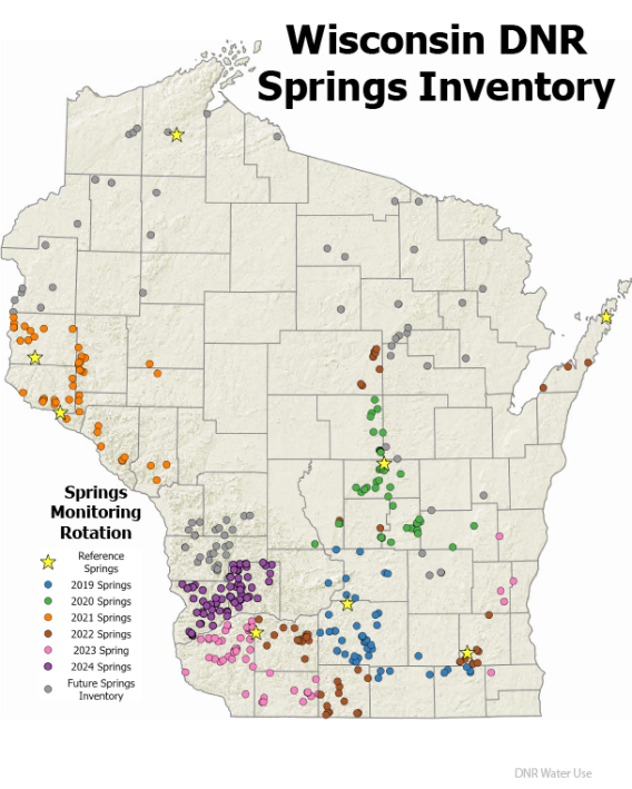 A map of Wisconsin showing county boundaries and locations of springs in the inventory. Most springs on the map are clustered in the SW portion of Wisconsin on the map. Springs are depicted on the map as colored circles, categorized by the year they were inventoried or when they will be studied in the future. Eight yellow stars on the map throughout the state indicate reference springs, or springs that DNR staff visit quarterly.