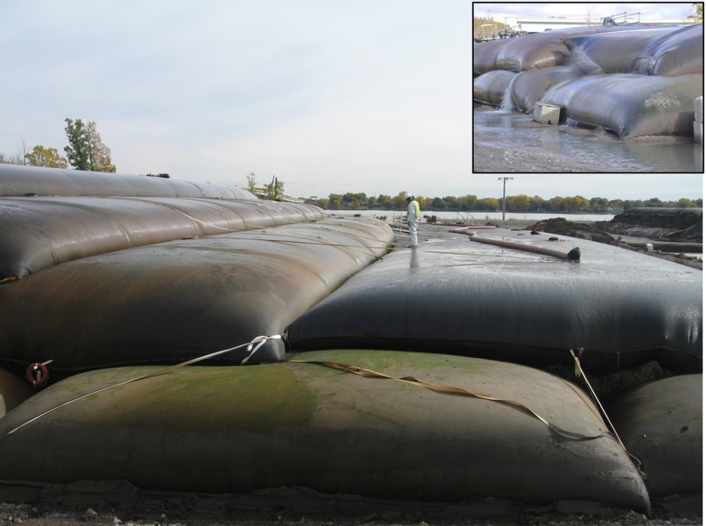 Field worker inspecting filled geotubes at the Ou-1 shore site. Photo Credit: The Boldt Co.