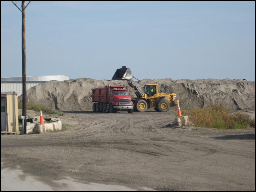 DNR staff loading separating sand for beneficial use in a red dump truck. Photo: The Boldt Co.