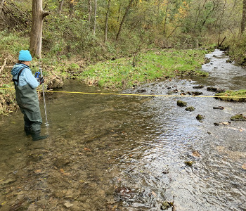 Measuring the streamflow at Highland Big Springs in Iowa County.