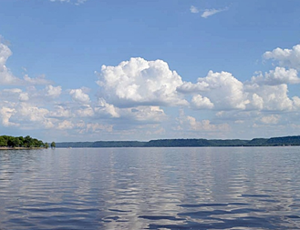 View of Lake Pepin with blue skies and Cumulus clouds off in the horizon.