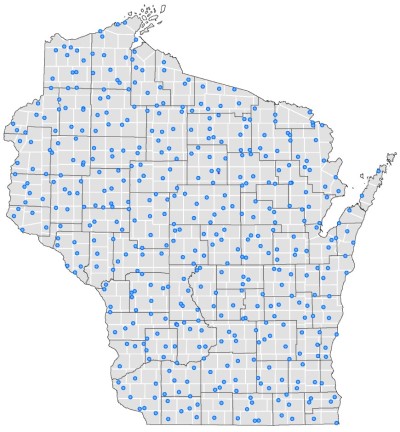 A map of  Wisconsin divided into a grid of 450 equal area cells outlined in white with a blue dot in each cell representing the randomly selected participant within that grid cell. 