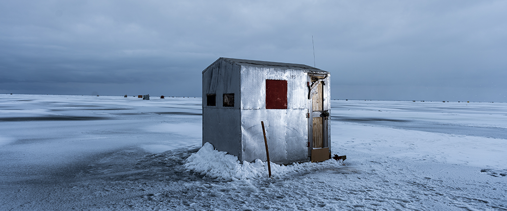 A lone sturgeon shanty sits under a grey sky