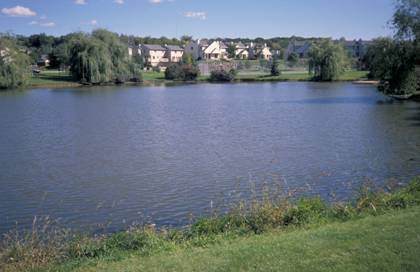 A detention basin (pond) near a residential area