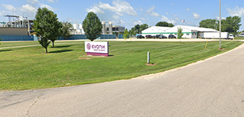 Evonik company sign in grassy area in front of the c