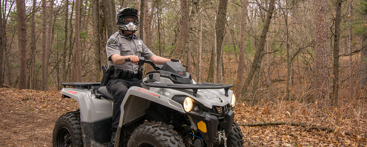 Warden on ATV in forest