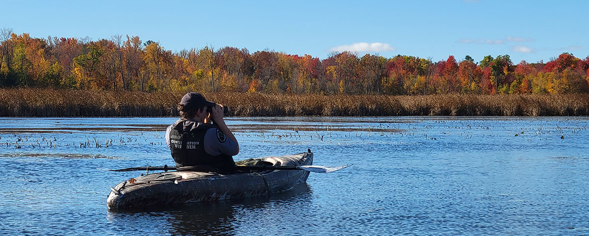 A warden patrols by kayak during the waterfowl season.